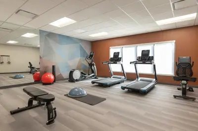 a gym with several treadmills and exercise machines at Candlewood Suites Pittston by IHG in Pittston