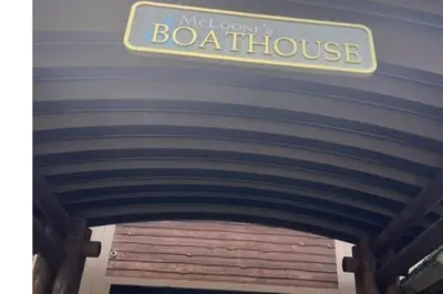 a sign that reads mind cows boathouse over a garage at Hollywood in East Orange