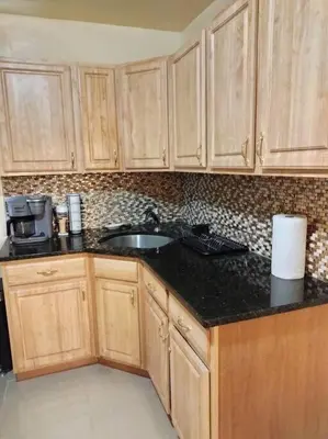 a kitchen with wooden cabinets and a sink at Hollywood in East Orange