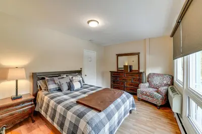 a bedroom with a bed and a chair at Massive Roscoe Retreat Great for Large Groups! in Roscoe