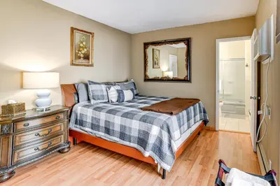 a bedroom with a bed and a dresser and a mirror at Massive Roscoe Retreat Great for Large Groups! in Roscoe