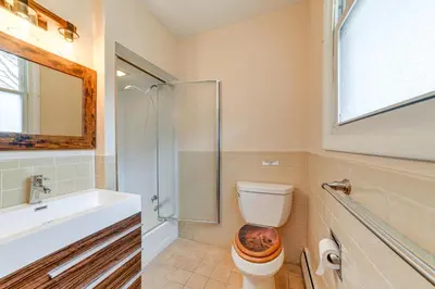 a bathroom with a toilet and a glass shower at Massive Roscoe Retreat Great for Large Groups! in Roscoe