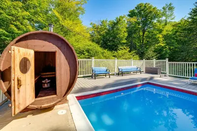 a wooden tub next to a swimming pool at Massive Roscoe Retreat Great for Large Groups! in Roscoe