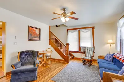 a living room with a ceiling fan and a table and chairs at Amish Country Townhome Near Hiking and Fly Fishing! in Loganton