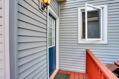 a house with a blue door and a window at Amish Country Townhome Near Hiking and Fly Fishing! in Loganton