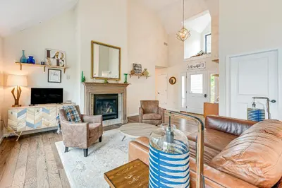 a living room with a couch and a fireplace at Lakefront Long Pond Home with Wraparound Deck! in Long Pond