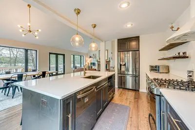 a kitchen with a large island and a dining room at Lakefront Long Pond Home with Wraparound Deck! in Long Pond
