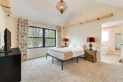 a bedroom with a bed and a window at Lakefront Long Pond Home with Wraparound Deck! in Long Pond