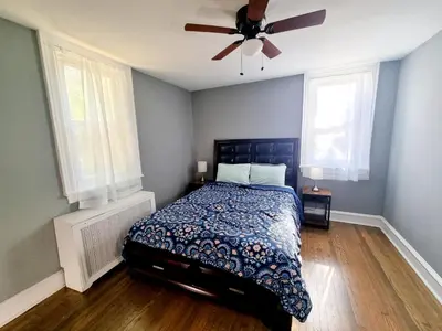 a bedroom with a bed and a ceiling fan at 1 Bedroom 1 Bath Apartment In Melrose Park in Elkins Park