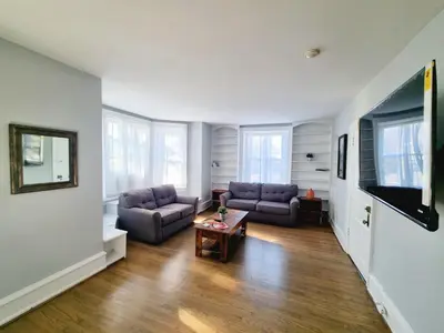 a living room with two couches and a table at 1 Bedroom 1 Bath Apartment In Melrose Park in Elkins Park