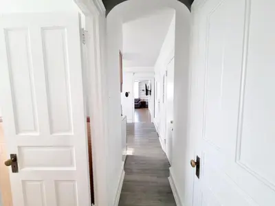 a hallway with white walls and white doors at 1 Bedroom 1 Bath Apartment In Melrose Park in Elkins Park
