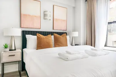 a bedroom with a white bed with two towels on it at 73-318 New Studio UWS Doorman Gym in New York