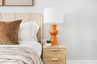 a lamp on a night stand next to a bed at 73-1503 Newly Reno Studio UWS Doorman Gym Laundry in New York