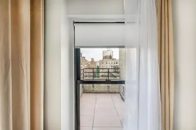 a view of a balcony from a room with a window at 73-1503 Newly Reno Studio UWS Doorman Gym Laundry in New York