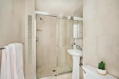 a bathroom with a shower and a sink and a toilet at 73-1503 Newly Reno Studio UWS Doorman Gym Laundry in New York