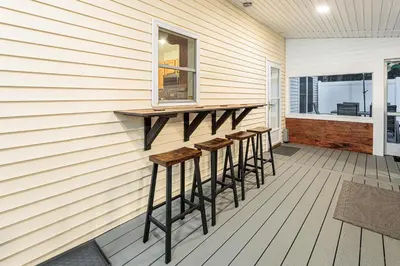 a bar on the side of a house with stools at 5mi to Big Boulder Hot tub Patio Firepit Fast WiFi in Blakeslee