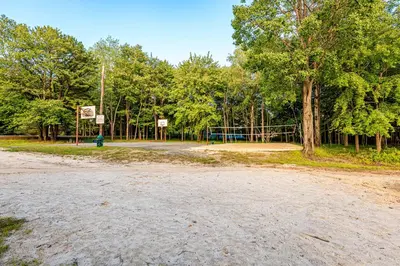 a dirt road with a basketball hoop in a park at 5mi to Big Boulder Hot tub Patio Firepit Fast WiFi in Blakeslee