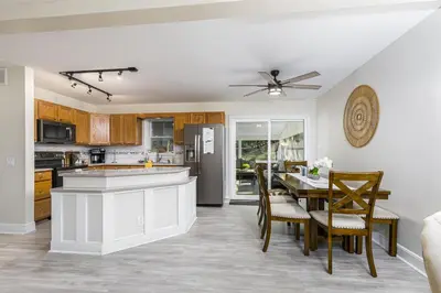 a kitchen and dining room with a table and chairs at 5mi to Big Boulder Hot tub Patio Firepit Fast WiFi in Blakeslee