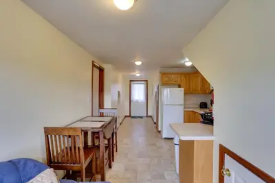 a kitchen and dining room with a table and refrigerator at Loganton Townhome, Near Fly Fishing and Hiking! in Loganton