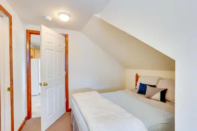 a bedroom with a bed and an open door at Loganton Townhome, Near Fly Fishing and Hiking! in Loganton