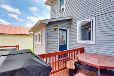 a wooden deck with a table and a house at Loganton Townhome, Near Fly Fishing and Hiking! in Loganton
