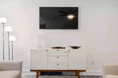 a white dresser in a living room with a ceiling at Family Friendly in the Heart of Mt Airy in Philadelphia