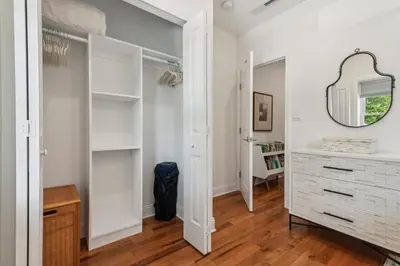 a bedroom with white walls and a mirror and a dresser at Family Friendly in the Heart of Mt Airy in Philadelphia