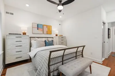 a bedroom with a bed and a dresser and a chair at Family Friendly in the Heart of Mt Airy in Philadelphia