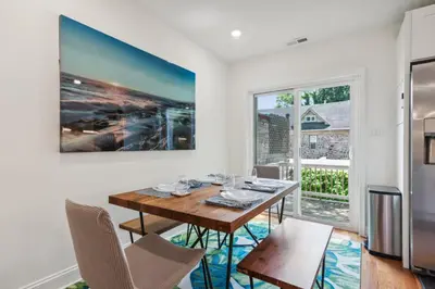 a dining room with a table and chairs and a large window at Family Friendly in the Heart of Mt Airy in Philadelphia