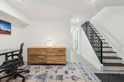 an office with a desk and a chair and a staircase at Family Friendly in the Heart of Mt Airy in Philadelphia