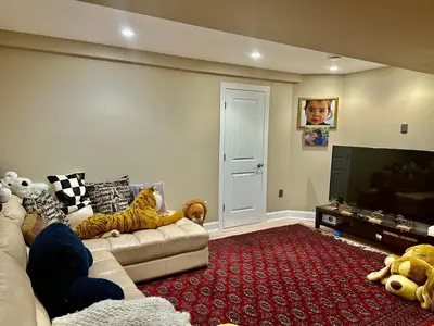 a living room with a couch and a flat screen tv at House in Bucks County in Perkasie