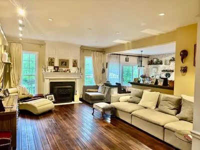 a living room with a couch and a fireplace at House in Bucks County in Perkasie