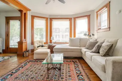 a living room with a couch and a coffee table at Victorian Home Sleeps 10 Fenced 4BR Full Kitchen Steps2 YCP in York