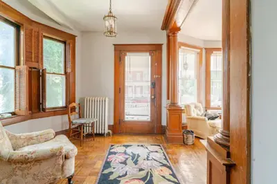 a living room with a couch and chairs and windows at Victorian Home Sleeps 10 Fenced 4BR Full Kitchen Steps2 YCP in York
