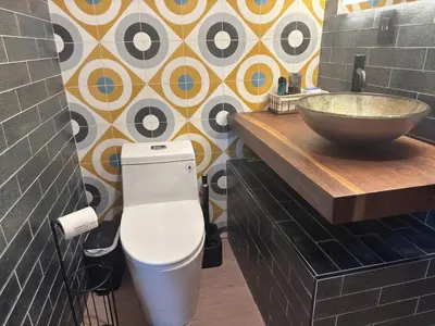 a bathroom with a sink and a toilet and a bowl at NEW! Urban Oasis, Chic 3-BR 2-BA Corner Unit, Steps Away from NYC! in Jersey City