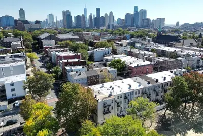 an aerial view of a city with skyscrapers at NEW! Urban Oasis, Chic 3-BR 2-BA Corner Unit, Steps Away from NYC! in Jersey City