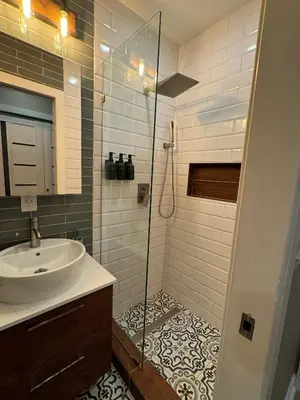 a bathroom with a sink and a glass shower at NEW! Urban Oasis, Chic 3-BR 2-BA Corner Unit, Steps Away from NYC! in Jersey City