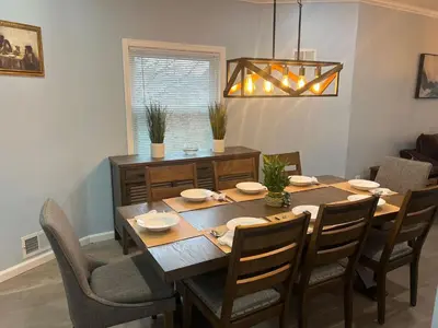 a dining room with a wooden table and chairs at Huge Family House 12 miles to NYC4BathParking in Belleville