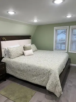 a bedroom with a large bed with pillows on it at Huge Family House 12 miles to NYC4BathParking in Belleville
