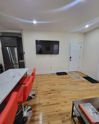 a room with a table and chairs and a flat screen tv at OoohLaLa! 2 Beds and 2 Full Baths w/Free Parking in Newark