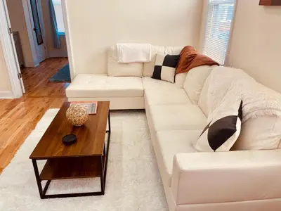 a white couch in a living room with a coffee table at OoohLaLa! 2 Beds and 2 Full Baths w/Free Parking in Newark
