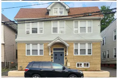 a black car parked in front of a house at OoohLaLa! 2 Beds and 2 Full Baths w/Free Parking in Newark