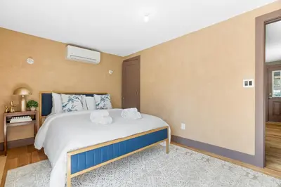a bedroom with a bed with two towels on it at Bronze Suite in Greenwood Lake
