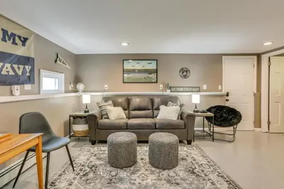 a living room with a couch and a table at Charming Highland Falls Home Less Than 2 Mi to West Point! in Highland Falls