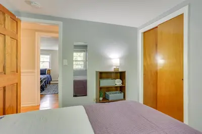 a bedroom with a bed and a door to a room at Charming Highland Falls Home Less Than 2 Mi to West Point! in Highland Falls