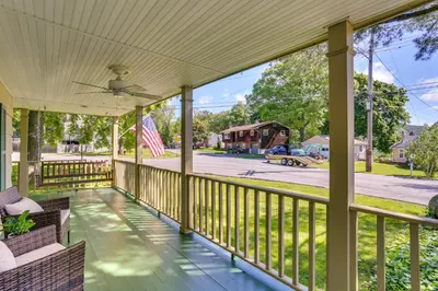 a screened porch with an american flag on it at Charming Highland Falls Home Less Than 2 Mi to West Point! in Highland Falls