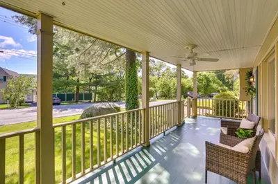 a screened porch with chairs and a ceiling fan at Charming Highland Falls Home Less Than 2 Mi to West Point! in Highland Falls