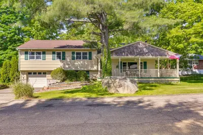 a house with a porch and a tree at Charming Highland Falls Home Less Than 2 Mi to West Point! in Highland Falls