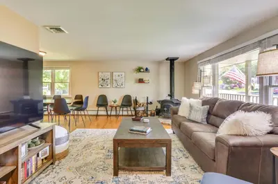 a living room with a couch and a table at Charming Highland Falls Home Less Than 2 Mi to West Point! in Highland Falls