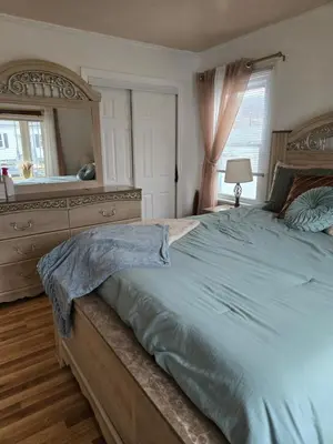 a bedroom with a large bed and a large mirror at House in New Jersey in Paterson